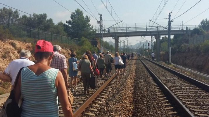 Passatgers caminant per les vies després d'una de les múltiples incidències a la xara ferroviària tarragonina. Foto: Carme Gaseni @kgaseni